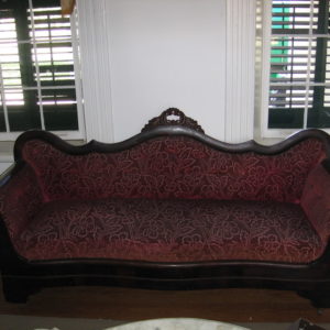 A couch with red and black fabric on it